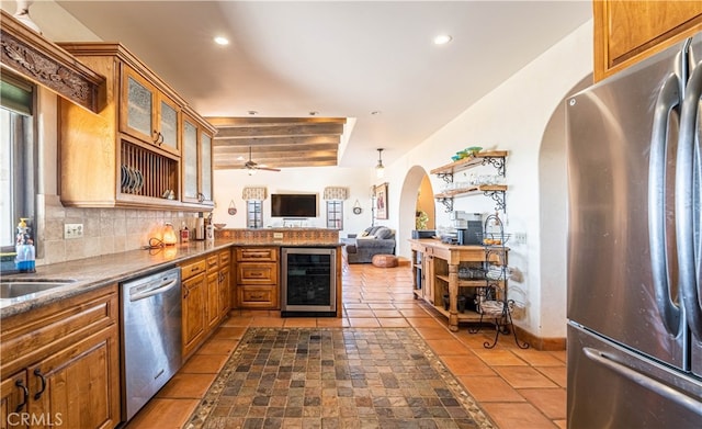 kitchen with beverage cooler, ceiling fan, light tile floors, tasteful backsplash, and stainless steel appliances