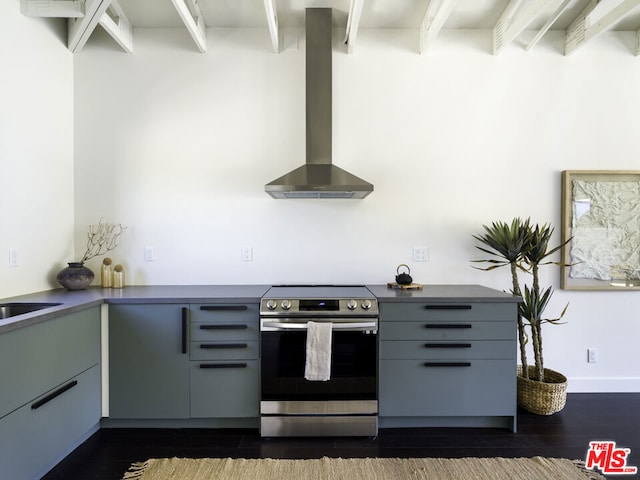 kitchen featuring dark hardwood / wood-style flooring, wall chimney range hood, and stainless steel electric range