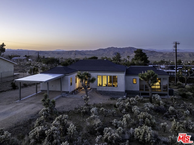 view of front of property featuring a carport and a mountain view