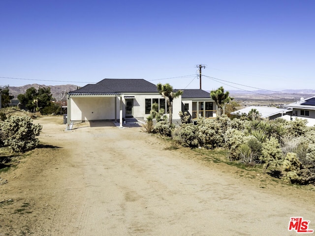 view of front facade with a carport and a mountain view