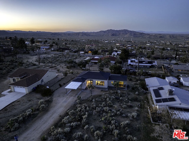 aerial view at dusk featuring a mountain view