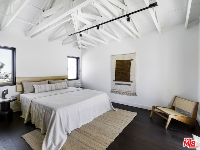 bedroom featuring vaulted ceiling with beams and dark hardwood / wood-style floors