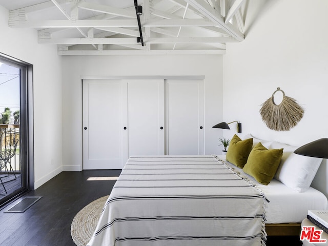 bedroom with high vaulted ceiling, access to exterior, and dark wood-type flooring