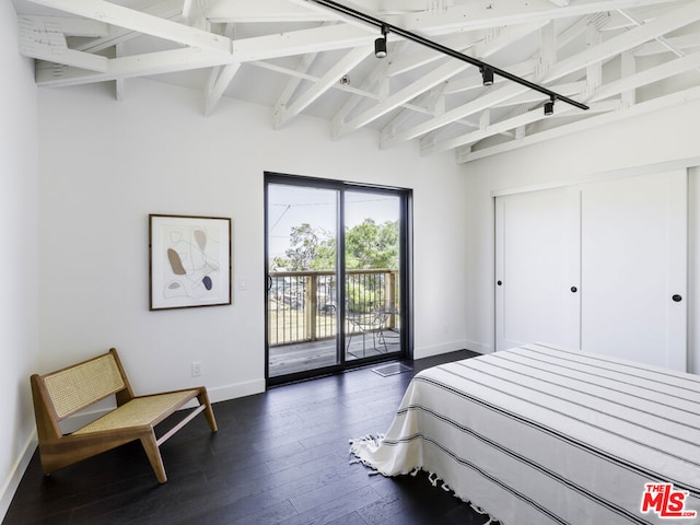 bedroom featuring access to outside, lofted ceiling with beams, and dark wood-type flooring