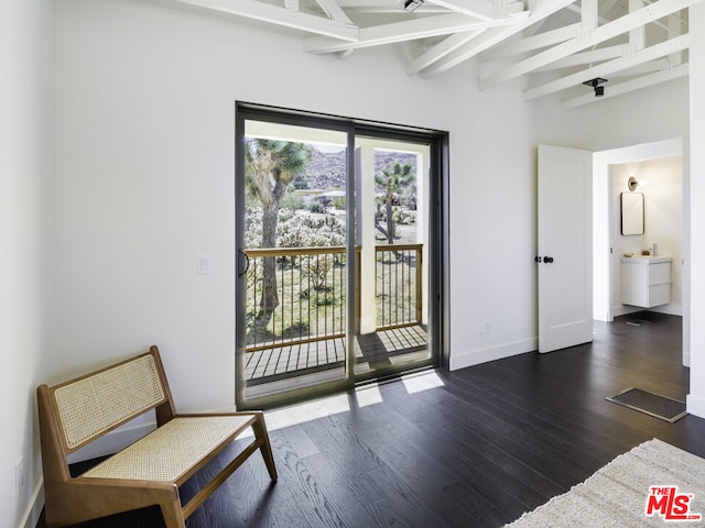 doorway featuring vaulted ceiling with beams and dark hardwood / wood-style floors