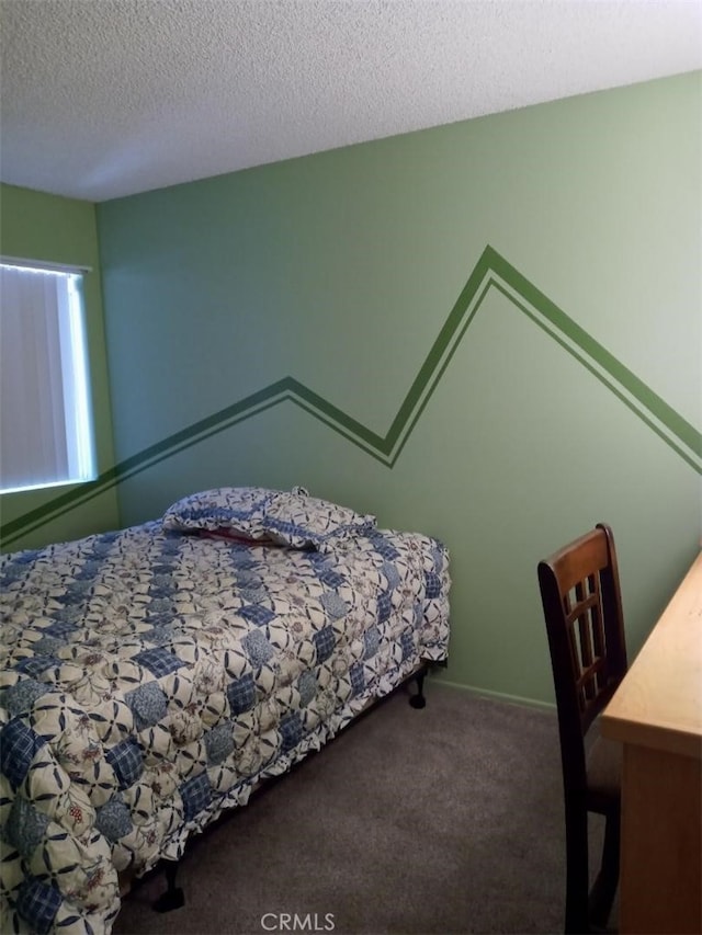 carpeted bedroom featuring a textured ceiling