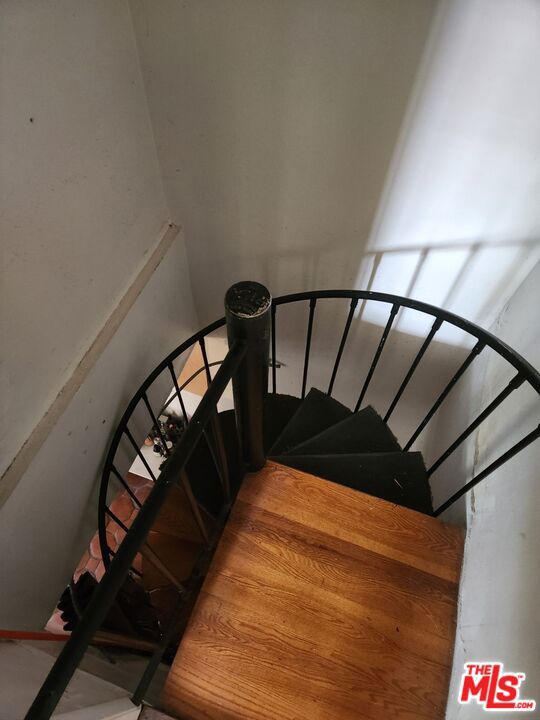 stairway featuring hardwood / wood-style floors