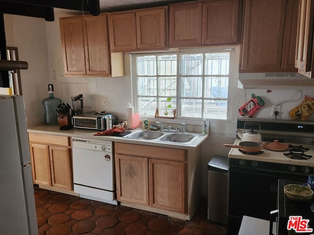 kitchen featuring dark tile floors, sink, wall chimney exhaust hood, and white appliances