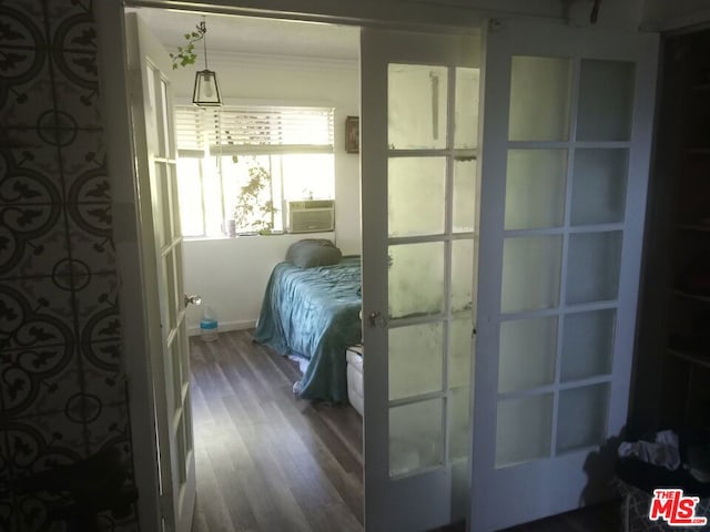 bedroom featuring french doors and wood-type flooring