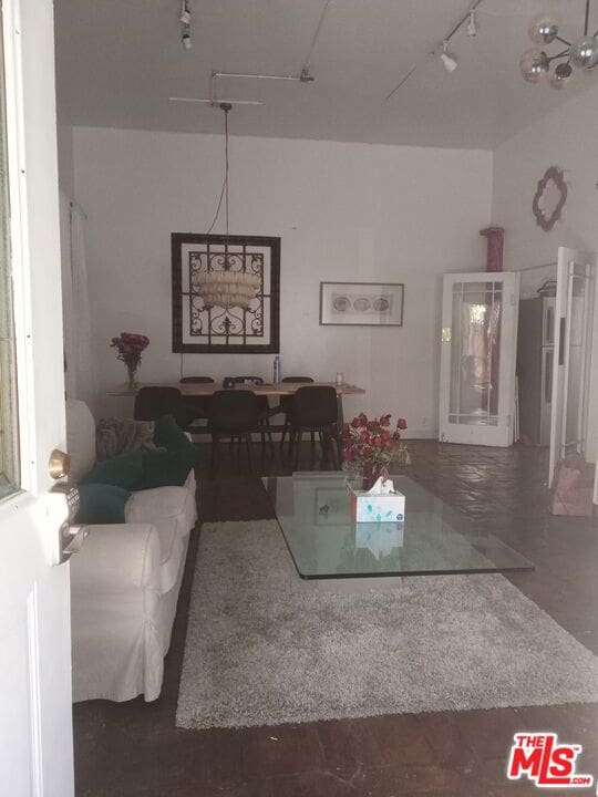 living room featuring concrete floors and rail lighting