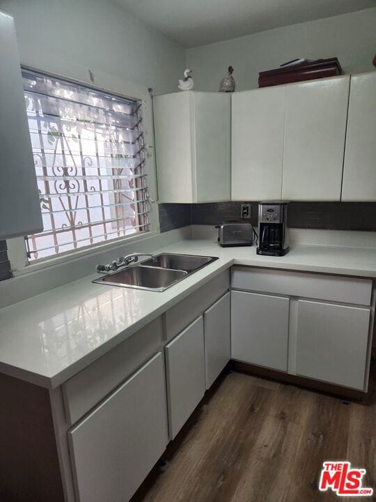 kitchen with white cabinets, sink, and dark hardwood / wood-style flooring