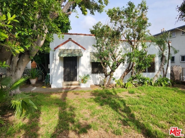 mediterranean / spanish-style house with a front lawn