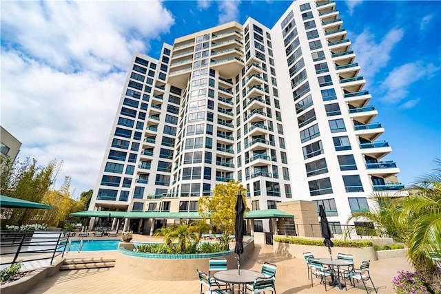 view of building exterior with a community pool