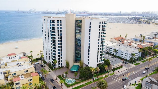 birds eye view of property with a view of the beach and a water view