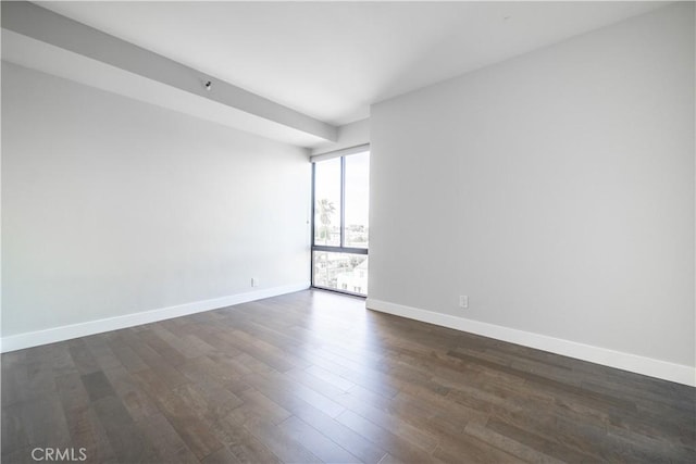 spare room with dark wood-type flooring