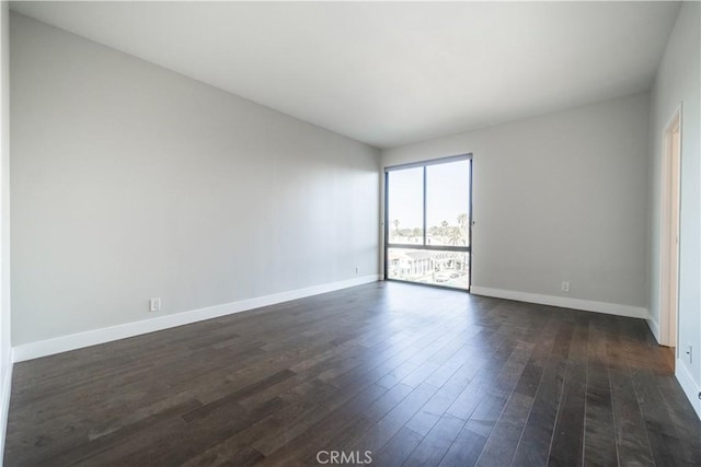 empty room featuring dark hardwood / wood-style flooring