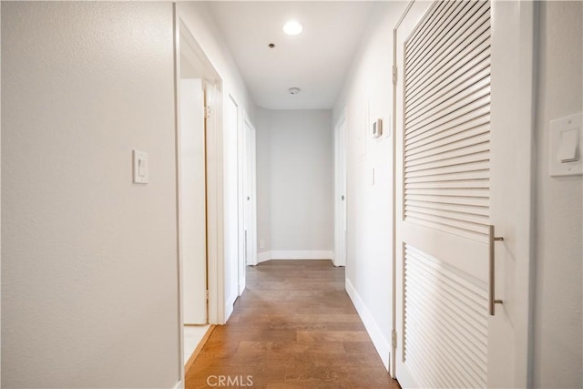 corridor with wood-type flooring