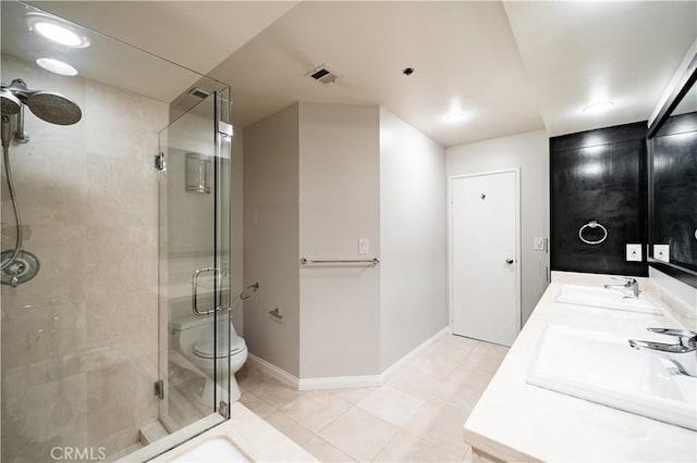 bathroom with tile patterned flooring, vanity, toilet, and a shower with shower door