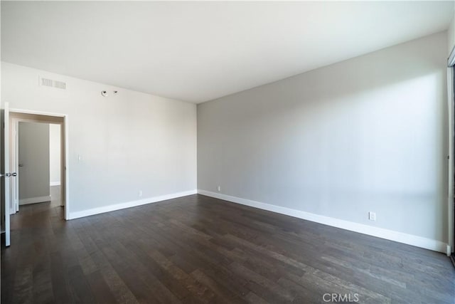 unfurnished room featuring dark wood-type flooring