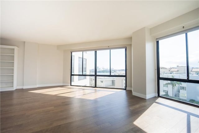 spare room featuring dark wood-type flooring