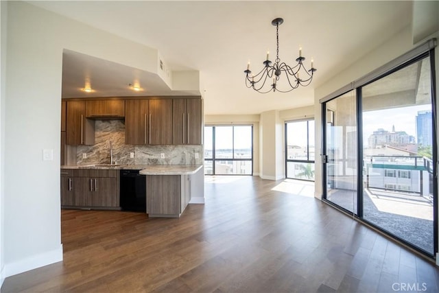 kitchen with dark hardwood / wood-style flooring, backsplash, pendant lighting, a chandelier, and black dishwasher