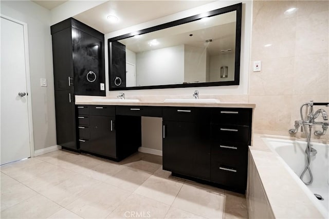 bathroom featuring a tub to relax in, tile patterned flooring, vanity, and tile walls