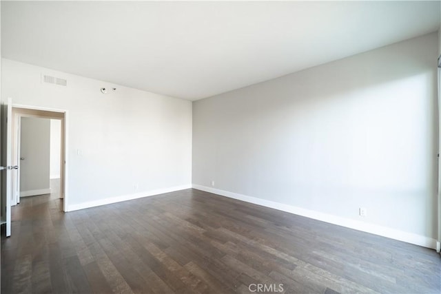 empty room with dark hardwood / wood-style floors