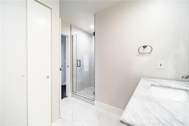 bathroom with vanity and a shower with shower door