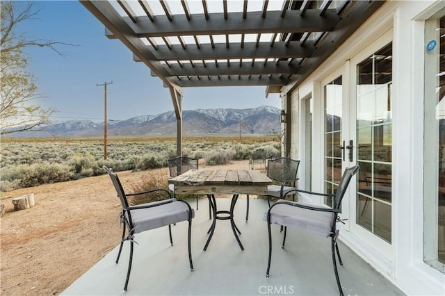 view of patio featuring a mountain view, a pergola, and a rural view