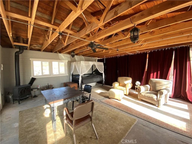 interior space featuring ceiling fan and a wood stove