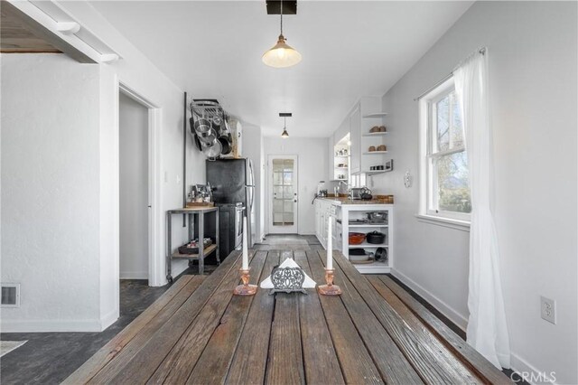 unfurnished dining area featuring dark wood-type flooring