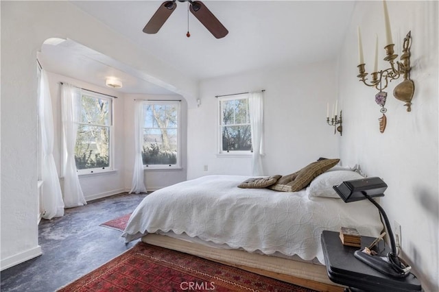 bedroom with multiple windows and ceiling fan