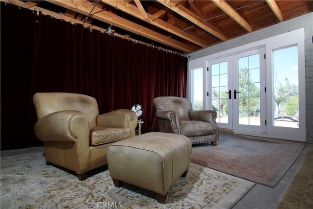 sitting room featuring beamed ceiling and french doors