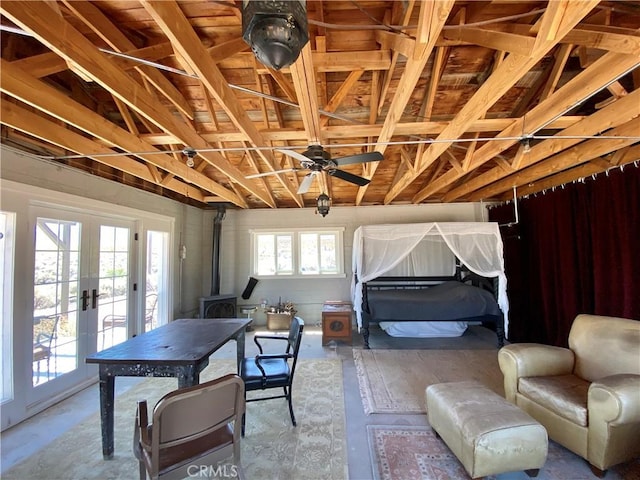 garage featuring a wood stove, ceiling fan, and french doors