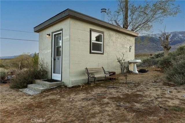 back of house with a mountain view