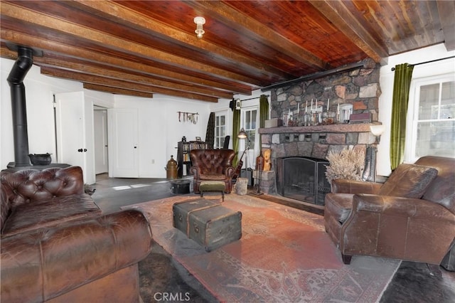 living room featuring a fireplace, beam ceiling, and wood ceiling