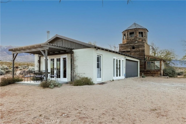 back of property with a patio and french doors