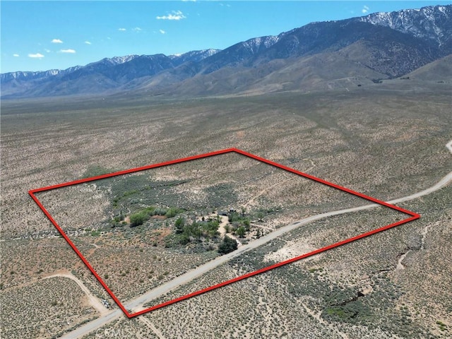 birds eye view of property with a mountain view