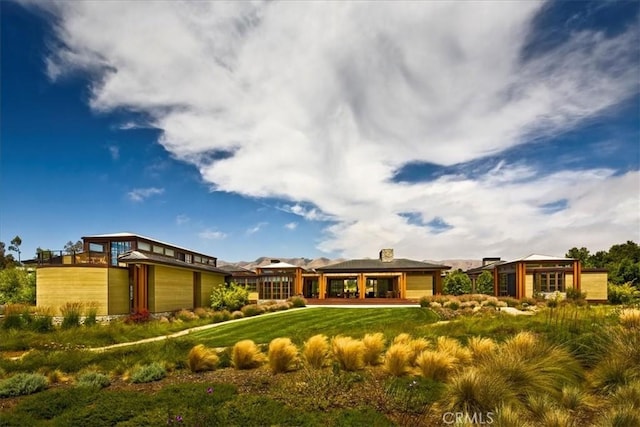 rear view of house with a yard