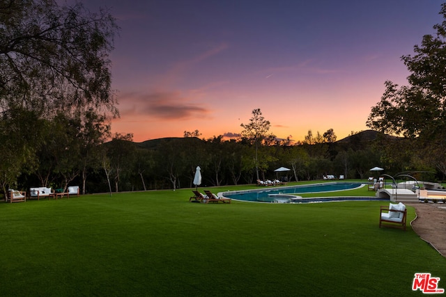 view of property's community featuring a mountain view and a yard