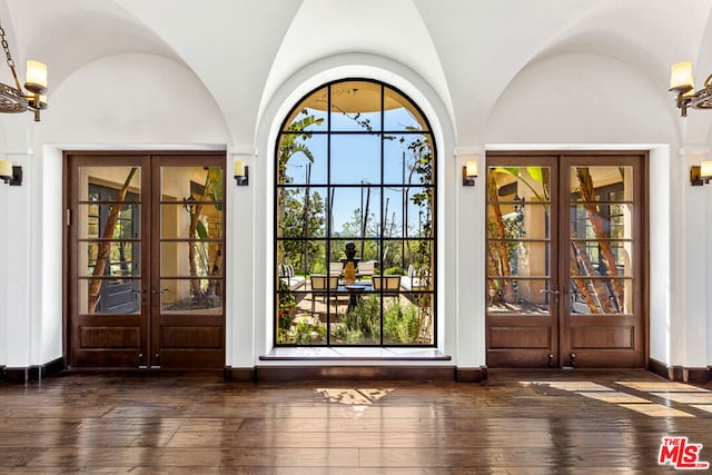 entryway featuring french doors, dark hardwood / wood-style flooring, and vaulted ceiling