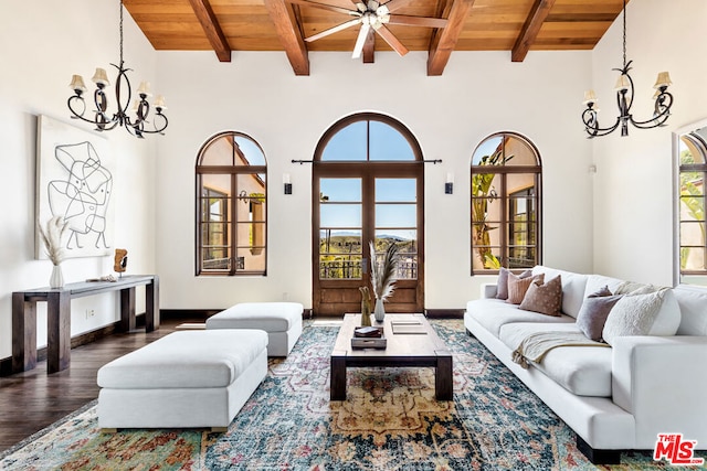 living room with ceiling fan with notable chandelier, wooden ceiling, hardwood / wood-style floors, and beamed ceiling