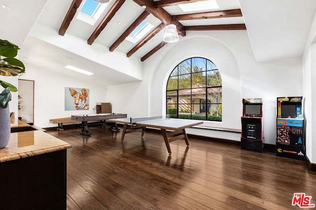 playroom featuring a skylight, ceiling fan, dark hardwood / wood-style flooring, high vaulted ceiling, and beam ceiling