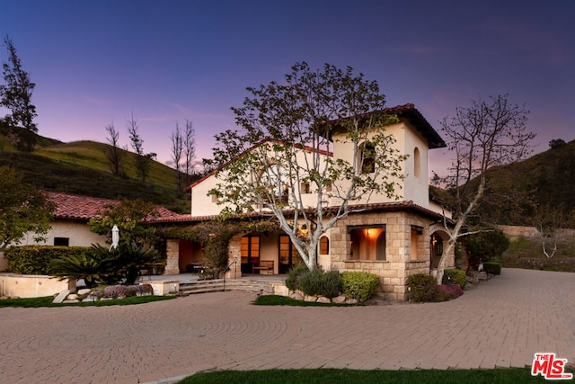 mediterranean / spanish-style house with a patio