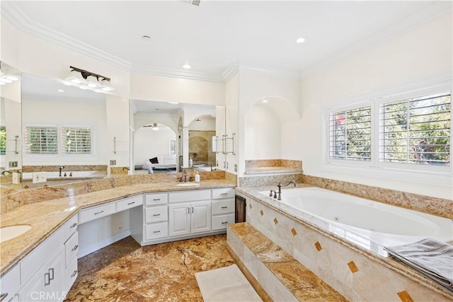 bathroom with vanity, crown molding, and a healthy amount of sunlight