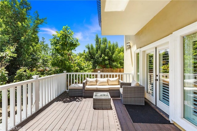 wooden terrace featuring an outdoor living space