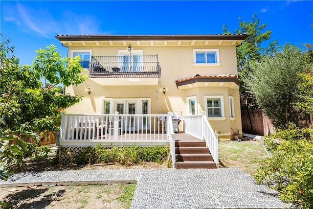 back of property with a balcony