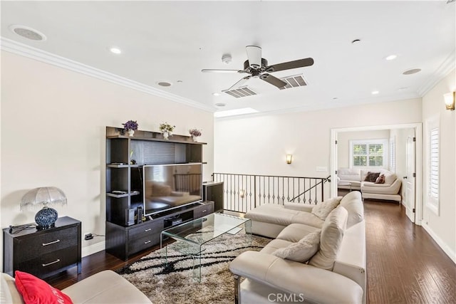 living room featuring dark hardwood / wood-style floors, ceiling fan, and ornamental molding