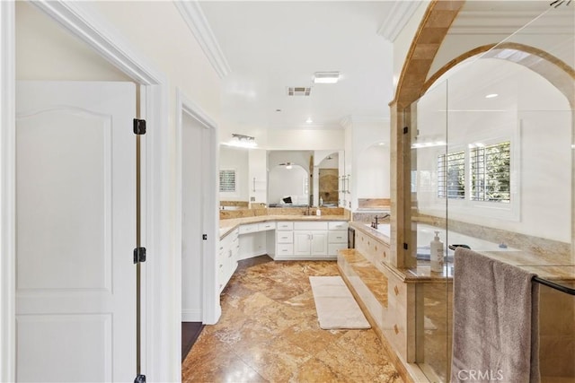 bathroom with vanity, crown molding, and independent shower and bath