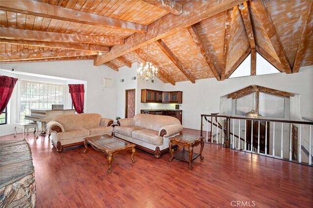 living room with vaulted ceiling with beams, a chandelier, and hardwood / wood-style flooring